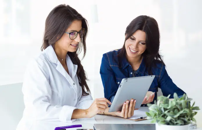 doctor her patient choosing mammary prosthesis office 2