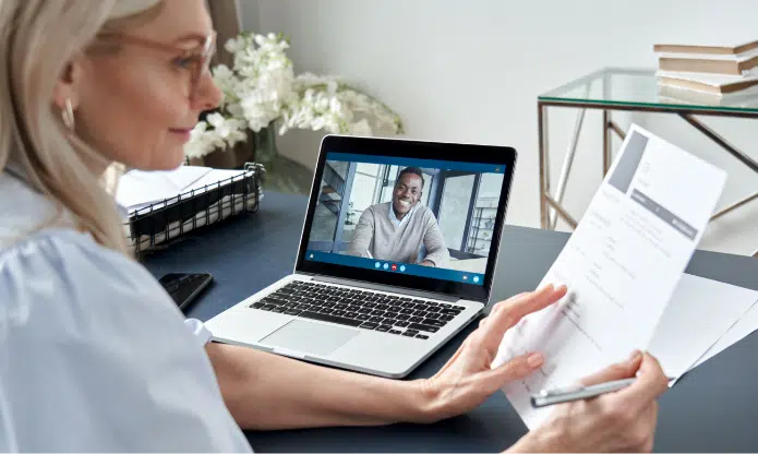 female hr reading cv during online virtual job interview by video call 3