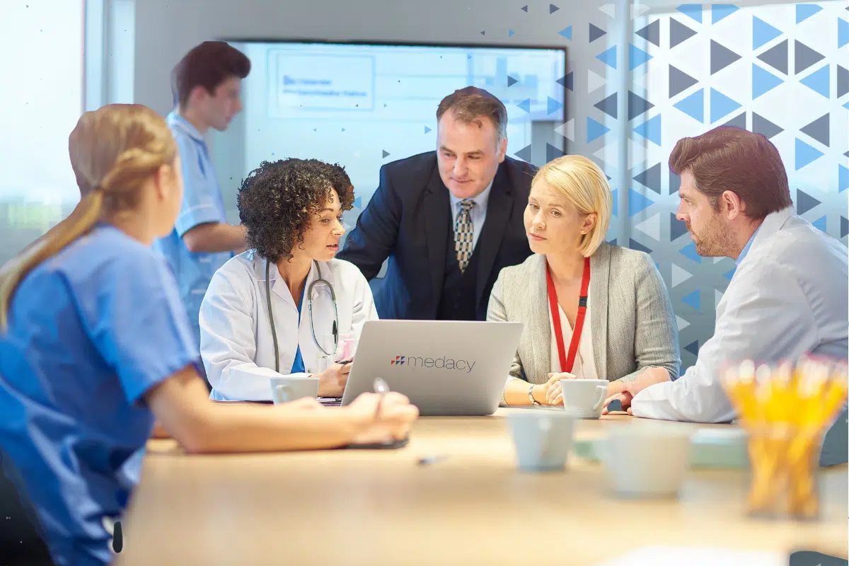 blog image for Network DES 2025/26 blog. Various healthcare professionals and management review workforce plans.