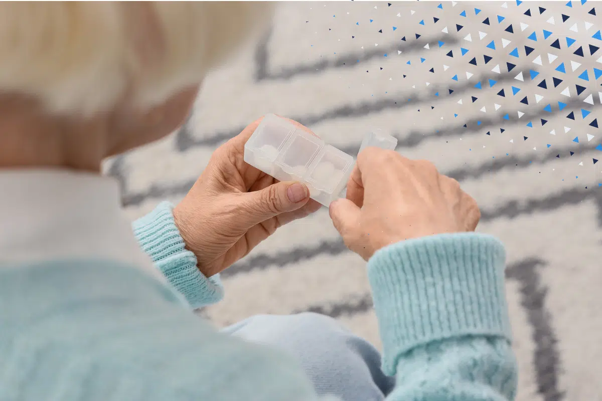 medication reviews for frailty blog hero image. An elderly lady looks at her pill pox